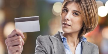 portrait of an executive young woman showing her credit card