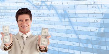 Successful businessman holding dollars