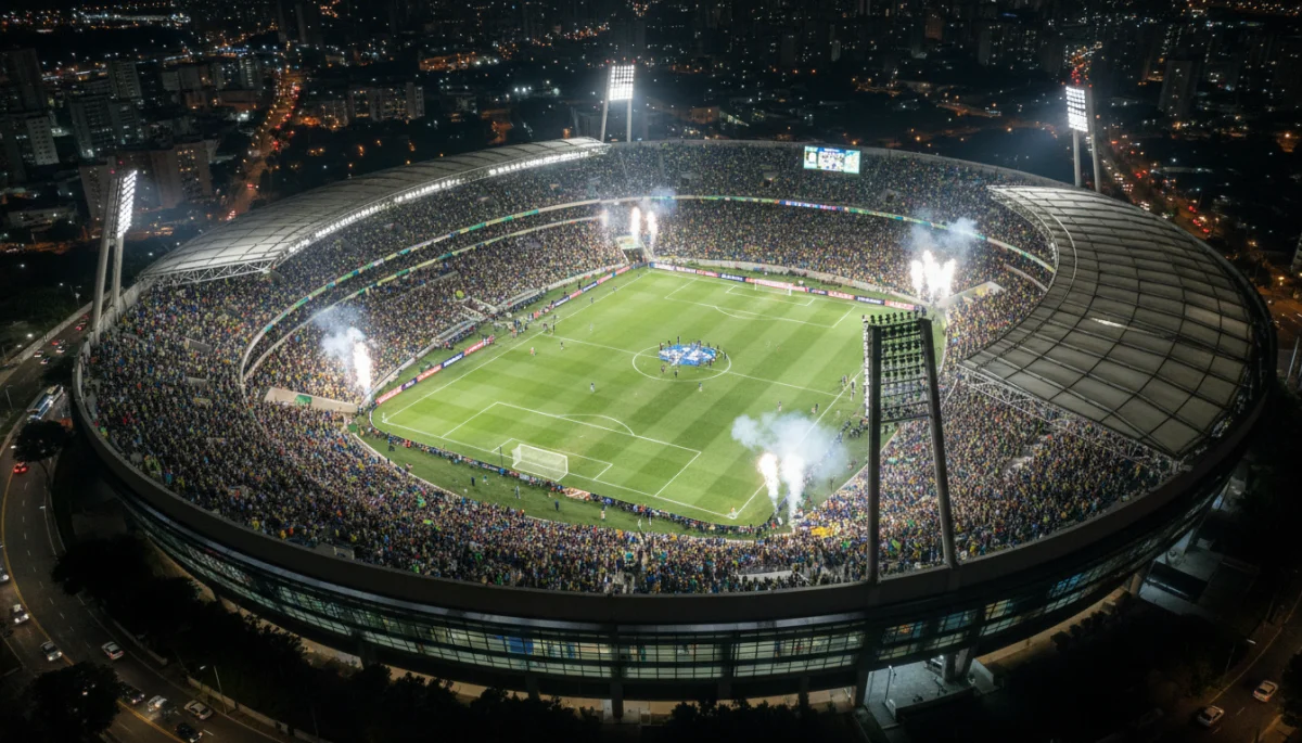 Vista aérea de um estádio de futebol moderno no Brasil, lotado de torcedores vibrantes durante um grande jogo.